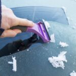 Eiskratzer im Einatz an der Autoscheibe