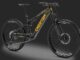 Full-suspension black mountain bike with yellow branding on the downtube, thick knobby tires, on a dark background.